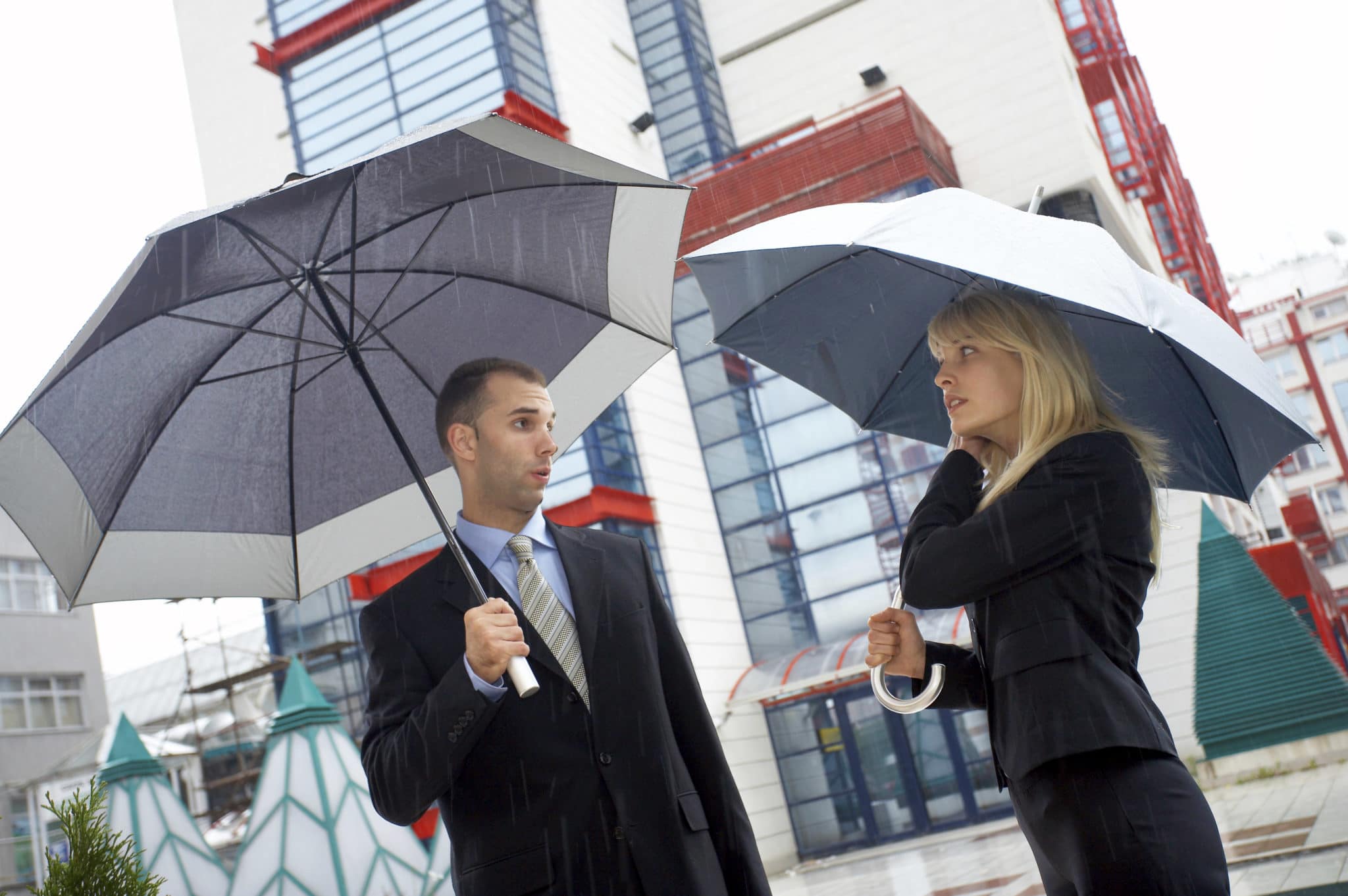 Business couple in rain