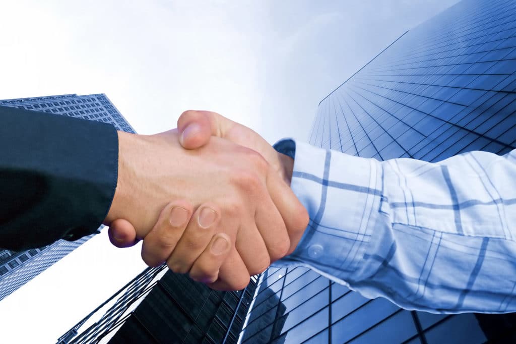 business hand shake deal in colour with a toned background to match colours family of sleeves